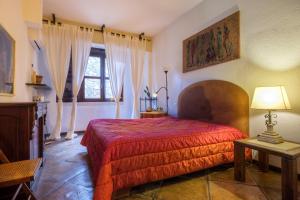 a bedroom with a red bed and a window at Gli Archi with pool - Lecce in Lecce +16 photos