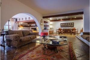 a living room with a couch and a table at Gli Archi with pool - Lecce in Lecce