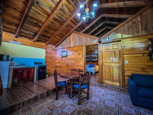a dining room with a table and chairs in a cabin at La Huerta in Mazamitla