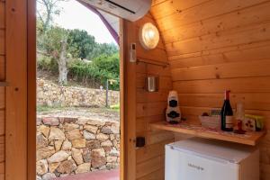 a door into a cabin with a refrigerator and a window at Terre di Tusa in Tusa
