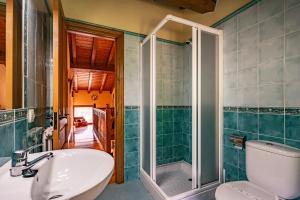 a bathroom with a shower and a toilet and a sink at Casa Mesilda in Para +22 photos