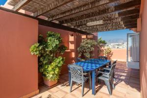 a blue table and chairs on a patio at Apartmento en Torrox Costa in Torrox Costa