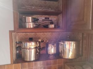 two pots and pans on a shelf in a kitchen at BB des 6 arcs"" in Coulonces +21 photos
