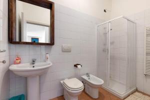 a bathroom with a sink and a toilet and a shower at B and B 7 Camini in Verona +53 photos