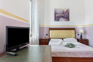 a bedroom with a bed with a flat screen tv at B and B 7 Camini in Verona