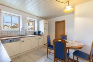 a kitchen and dining room with a table and chairs at Ferienwohnung Schönhals in Herbstein