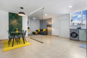 a living room and dining room with a table and chairs at Tea-Rose Loft in Conil