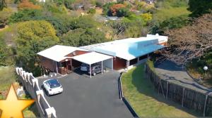 an aerial view of a house with a car parked in the driveway at Badumetsie cottage in Durban
