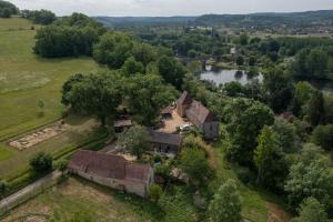 an aerial view of a house and a river at Domaine De Vic in Saint-Chamassy