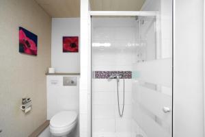 a white bathroom with a shower and a toilet at Domaine De Vic in Saint-Chamassy +26 photos
