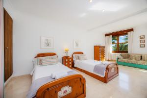a bedroom with two beds and a couch at Can Gual Inca in Inca +24 photos