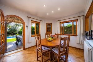 a kitchen and dining room with a wooden table and chairs at Can Gual Inca in Inca