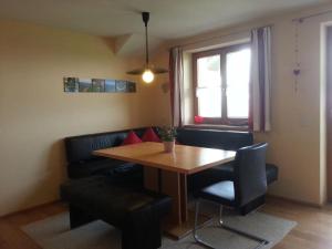 a living room with a table and a couch at Haus Schwärzler in Stiefenhofen