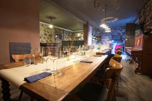 a long wooden table with wine glasses on it at Fewos Weingut Pieper Basler in Offenburg