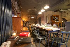 a restaurant with a long table with chairs in a room at Fewos Weingut Pieper Basler in Offenburg