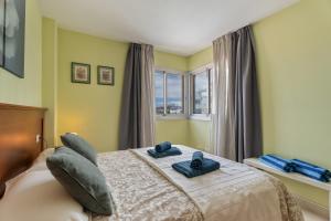a bedroom with a bed with blue towels on it at Apartamento Sol Paraiso in Adeje +24 photos
