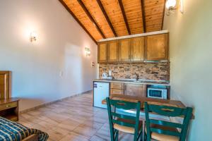 a kitchen with a table and chairs in a room at Mirage Arillas Studio Type C18 in Arillas +12 photos