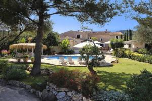 a house with a swimming pool in a yard at Can Verd Vall De Colonya in Pollença