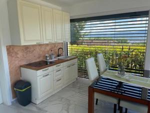 a kitchen with a sink and a table and a keyboard at Počitniška hiška SEA HIDEAWAY in Ankaran