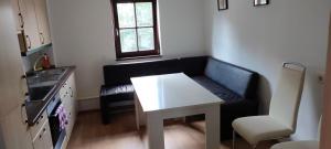 a small living room with a couch and a table at Käfer D in Waldbrunn +7 photos