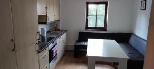 a kitchen with a couch and a table in a room at Käfer D in Waldbrunn