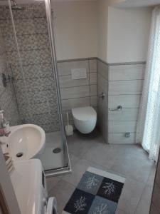 a bathroom with a shower and a sink and a toilet at bilocale con il mare dentro in Bonassola +20 photos