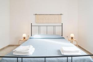 a bedroom with a bed with two towels on it at Villa Francesco P Terra in Orosei