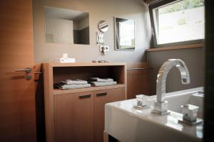 a bathroom with a sink and a mirror at Gästehaus im Weingut am Stein in Würzburg +17 photos