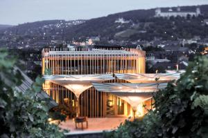 a lit up building with a view of a city at Gästehaus im Weingut am Stein in Würzburg