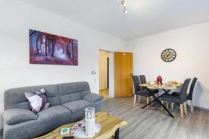 a living room with a couch and a table at Ferienwohnung Astrid in Sundern
