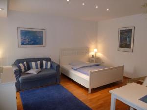 a bedroom with a bed and a chair at Ferienwohnung Dora Brand in Arnsberg