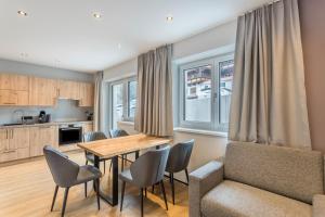 a kitchen and dining room with a table and chairs at Luisalle Top 2 in Auffach