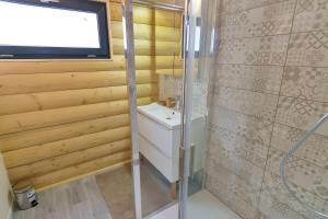 a bathroom with a shower and a tv on the wall at Charming Chalet 3 étoiles - 10 pers in Courchevel +14 photos