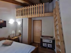 a bedroom with a bunk bed and a ladder at Charming Chalet 3 étoiles - 10 pers in Courchevel