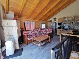 a living room with a couch and a table at Charming Chalet 3 étoiles - 10 pers in Courchevel