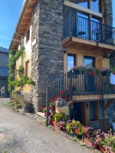 a stone house with flowers on the side of it at Charming Chalet 3 étoiles - 10 pers in Courchevel