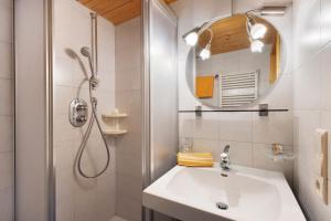 a white bathroom with a sink and a shower at Mattleitenhof in Santa Maddalena +49 photos