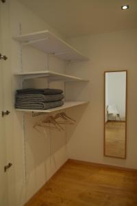 a room with shelves and a mirror and a table at Appartment Gut Wendlandt in Bolzano +10 photos