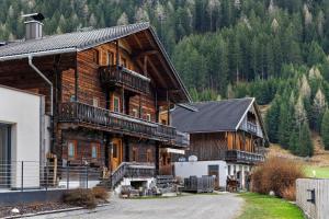 a large log cabin with a driveway in front at Mattleitenhof in Santa Maddalena