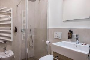 a bathroom with a shower and a sink and a toilet at Apartment Annabel in Bolzano