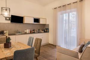 a living room with a dining table and a kitchen at Apartment Annabel in Bolzano