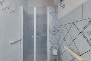 a shower with a glass door in a bathroom at Samarighouse in Putzu Idu +16 photos