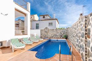 a villa with a swimming pool and a house at Villa Zoe in Nerja