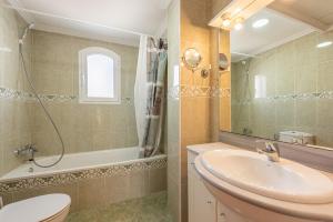 a bathroom with a sink and a toilet and a mirror at Villa Zoe in Nerja +15 photos