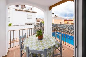 a table on a balcony with a potted plant on it at Villa Zoe in Nerja