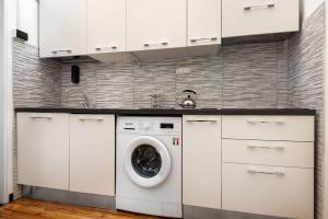 a white kitchen with a washing machine in it at Apartment baia del silenzio beach in Sestri Levante