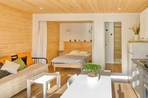 a living room with a bed and a couch at La Dune de Sable - Cavaro in Pornichet