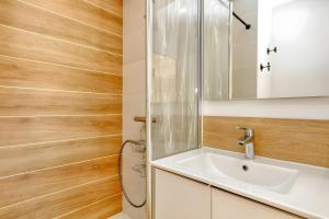 a bathroom with a sink and a toilet at La Dune de Sable - Cavaro in Pornichet