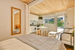 a bedroom with a bed and a table and a kitchen at La Dune de Sable - Cavaro in Pornichet