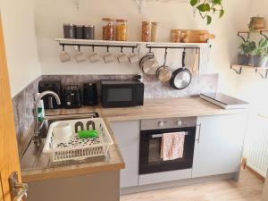 a small kitchen with a sink and a stove at Lush Rooms Bedminster in Bristol